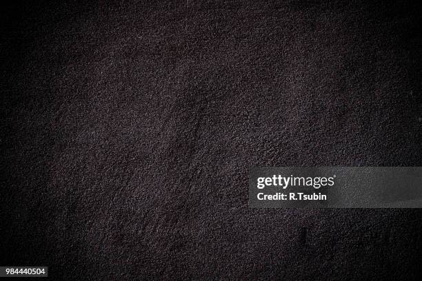 dark edged wall asphalt texture background - schottergestein stock-fotos und bilder