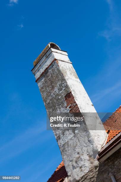old brick chimney on orange tile roof (blue sky) - soot stock pictures, royalty-free photos & images