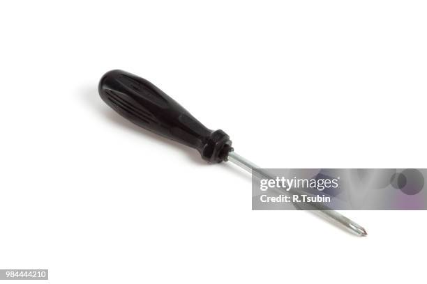 black screwdriver on white background - schraubenzieher stock-fotos und bilder