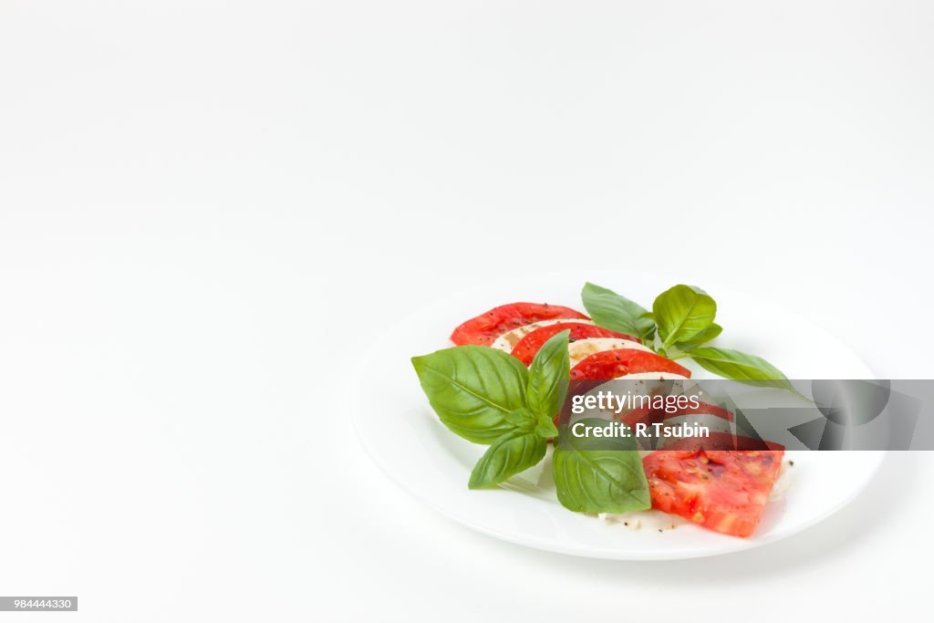 Mozzarella, arugula & tomato salad on a white plate