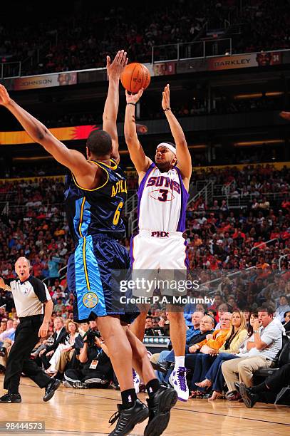 Jared Dudley of the Phoenix Suns shoots over Arron Afflalo of the Denver Nuggets in an NBA Game played on April 13, 2010 at U.S. Airways Center in...