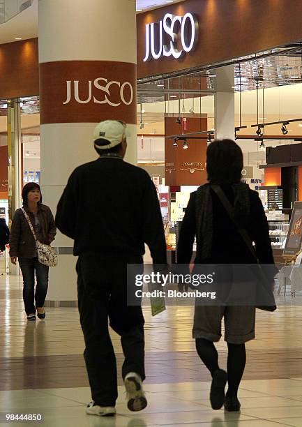 Shoppers pass in front of a Jusco store at the Aeon Lake Town shopping mall in Koshigaya City, Saitama Prefecture, Japan, on Wednesday, April 14,...