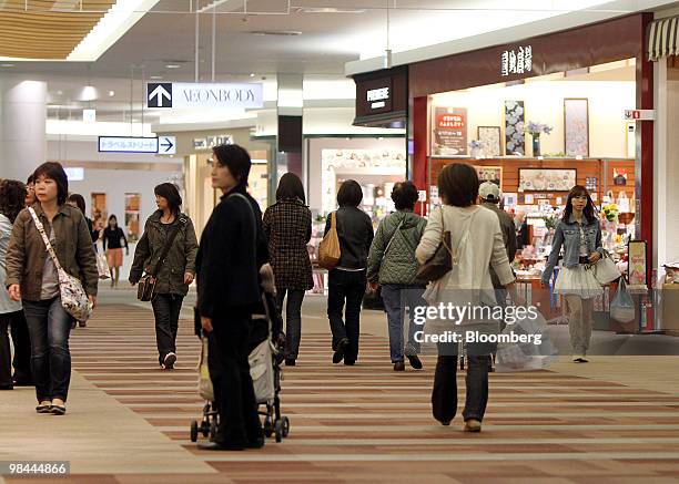 Shoppers walk through the Aeon Lake Town shopping mall in Koshigaya City, Saitama Prefecture, Japan, on Wednesday, April 14, 2010. Aeon Co., Japan's...