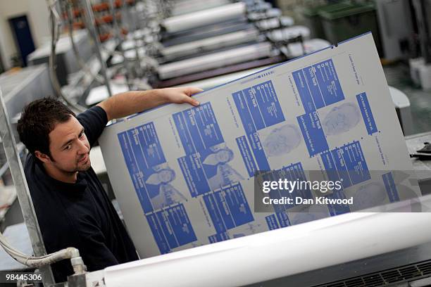 An employee of Anton Group Printers loads sheet into a CutStar sheeter in the first process of printing Labour Party election material on April 13,...