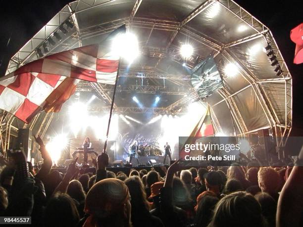 Nightwish perform on stage to an enthusiastic festival crowd including many waving large flags on poles, at Bloodstock Open Air on August 17th, 2008...