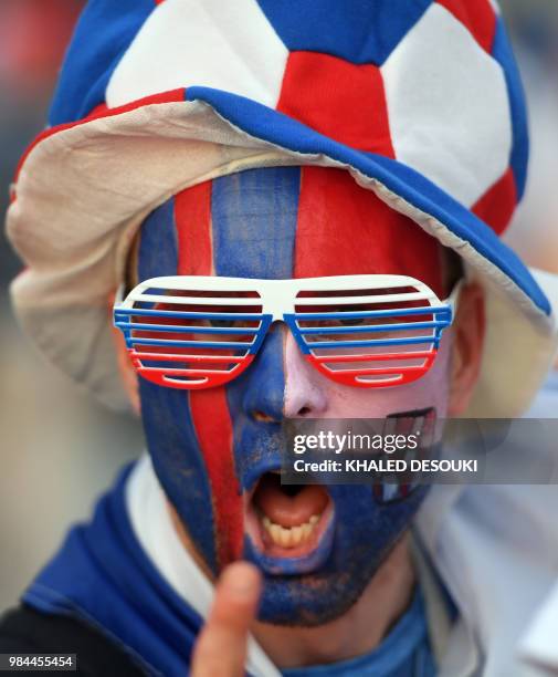 Fan with half his face painted with the Icelandic flag and the other half with the Croatian one poses before the Russia 2018 World Cup Group D...