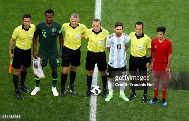 Lionel Messi of Argentina, John Obi Mikel of Nigeria, Referee Cuneyt Cakir ad llinesmen pose prior to the 2018 FIFA World Cup Russia group D match...