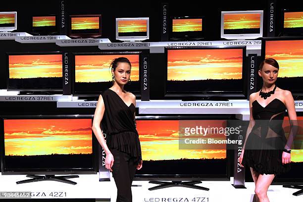 Models pose in front of Toshiba Corp.'s "LED Regza" liquid crystal display televisions displayed at an unveiling in Tokyo, Japan, on Wednesday, April...