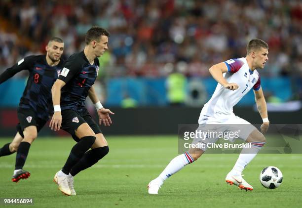 Johann Gudmundsson of Iceland runs with the ball under pressure from Ivan Perisic of Croatia during the 2018 FIFA World Cup Russia group D match...