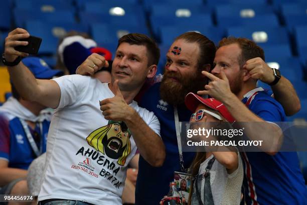 Supporters pose for a selfie ahead of the Russia 2018 World Cup Group D football match between Iceland and Croatia at the Rostov Arena in...