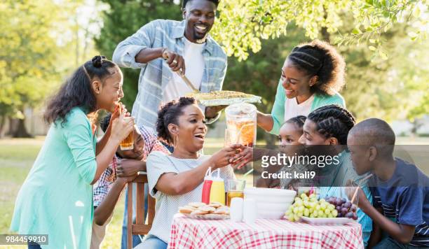 large african-american family having backyard cookout - black family reunion stock pictures, royalty-free photos & images