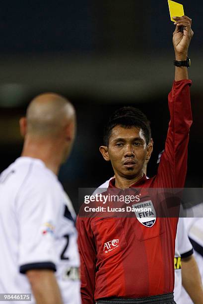 Referee gives Kevin Muscat of the Victory a yellow card during the AFC Champions League group E match between Melbourne Victory and Beijing at Etihad...