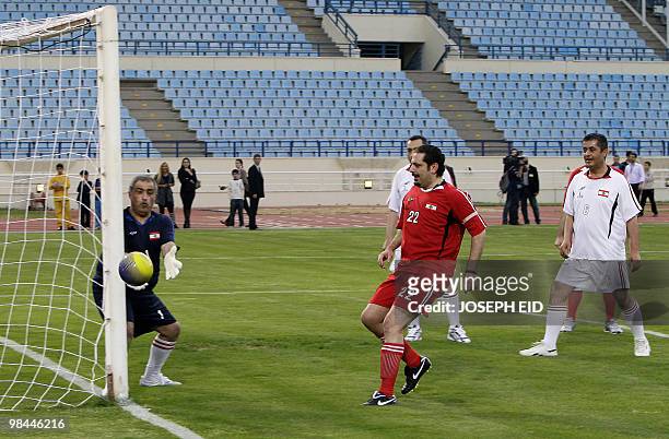 Lebanese Prime Minister Saad Hariri kicks the ball during a friendly football match against a team headed by Hezbollah MP Ali Ammar in Beirut's...