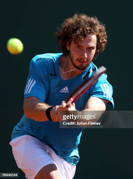 Ernests Gulbis of Latvia plays a backhand in his match against Stanislas Wawrinka of Switzerland during day three of the ATP Masters Series at the...