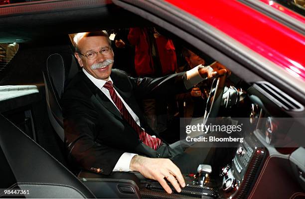 Dieter Zetsche, chief executive officer of Daimler AG, poses in a Mercedes SLS AMG automobile at the company's annual shareholder's meeting in...