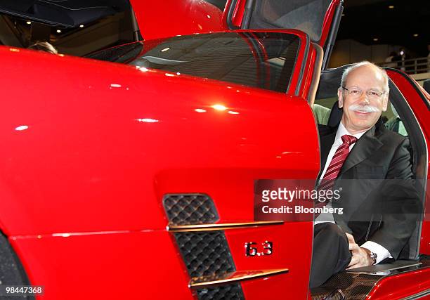 Dieter Zetsche, chief executive officer of Daimler AG, poses in a Mercedes SLS AMG automobile at the company's annual shareholder's meeting in...