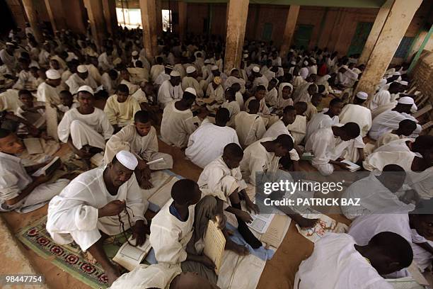 Sudanese Sufi students recite verses of the Koran at the Qadiriya Sufi school in the village of Umm Dawban, 40 kms north of Khartoum, on April 13,...