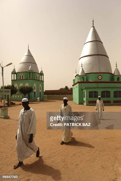Sudanese Sufi students walk past shrines at the Qadiriya Sufi school in the village of Umm Dawban, 40 kms north of Khartoum, on April 13, 2010. In...