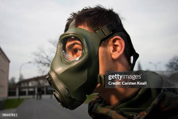 Young recruit of the Bundeswehr guard of honour tries a abc-protection mask on at the Julius Leber barracks on April 14, 2010 in Berlin, Germany....