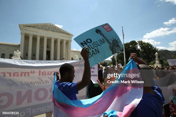 People demonstrate against U.S. President Trump's travel ban as protesters gather outside the U.S. Supreme Court following a court issued immigration...