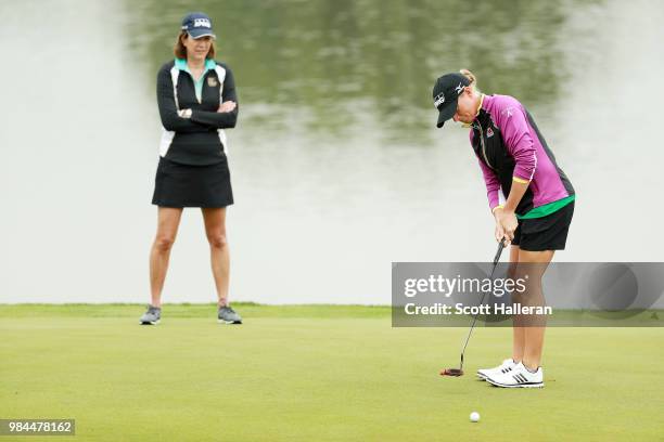 Lynne Doughtie, Chairman and CEO of KPMG, waits on a green alongside Stacy Lewis during the pro-am prior to the start of the KPMG Women's PGA...