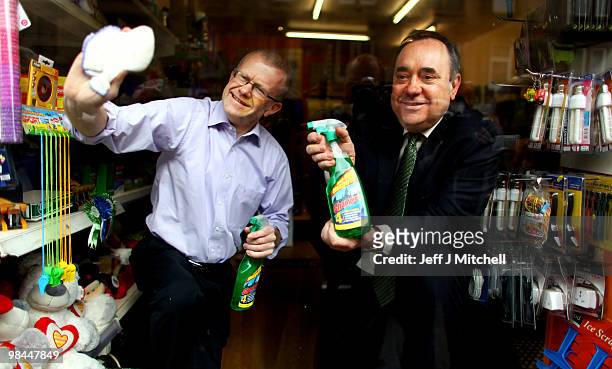 Leader Alex Salmond and SNP candidate John Mason clean a shop window while on the campaign trail on April 14, 2010 in Glasgow, Scotland. The General...