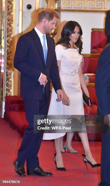 Prince Harry, Duke of Sussex and Meghan, Duchess of Sussex at the Queen's Young Leaders Awards Ceremony at Buckingham Palace on June 26, 2018 in...