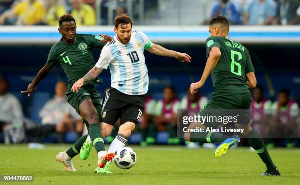 Lionel Messi of Argentina is tackled by Leon Balogun and Wilfred Ndidi of Nigeria during the 2018 FIFA World Cup Russia group D match between Nigeria...