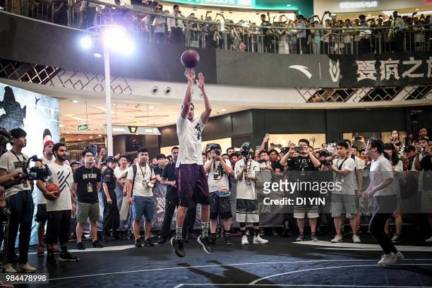 Player Klay Thompson of the Golden State Warriors shoots a three point basket in a fans meeting on June 26, 2018 in Zhengzhou, China.