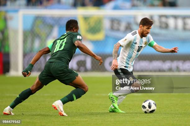 Lionel Messi of Argentina is challenged by John Obi Mikel of Nigeria during the 2018 FIFA World Cup Russia group D match between Nigeria and...