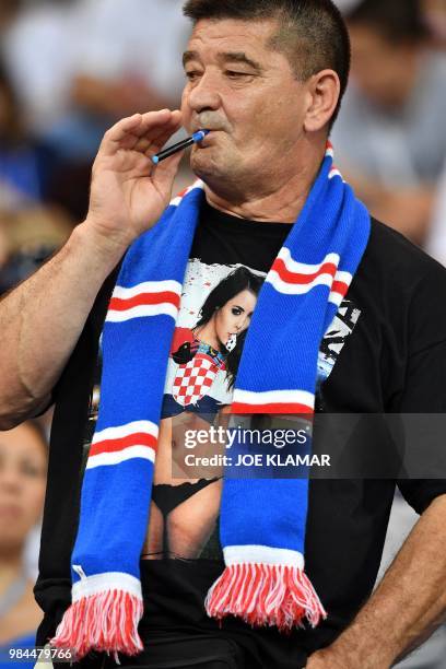 Croatia's supporter poses ahead of the Russia 2018 World Cup Group D football match between Iceland and Croatia at the Rostov Arena in Rostov-On-Don...
