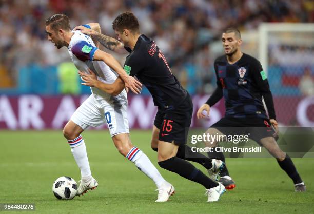 Gylfi Sigurdsson of Iceland is challenged by Duje Caleta-Car of Croatia during the 2018 FIFA World Cup Russia group D match between Iceland and...