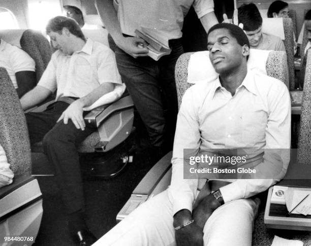 Boston Celtics' Robert Parish, left, and Larry Bird nap on a flight home from Detroit at the conclusion of the second round of the 1987 NBA playoffs...