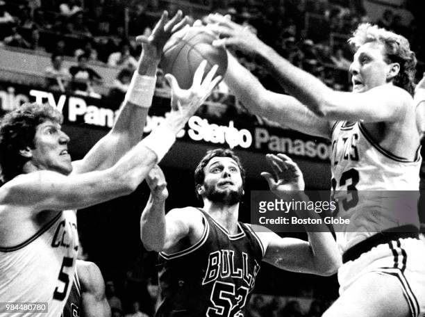 From left, Boston Celtics' Bill Walton, Chicago's Mike Smrek and the Celtics' Larry Bird reach for the ball during the first quarter. The Boston...