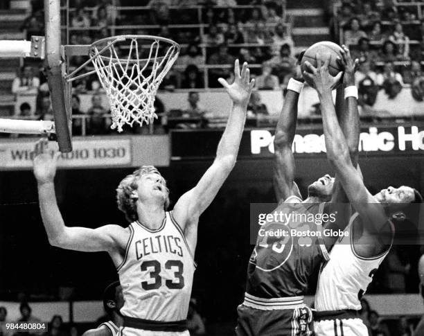 Boston Celtics' Larry Bird, left, and Cedric Maxwell, right, try to block a shot by the Warriors' Larry Smith during the second quarter. The Boston...