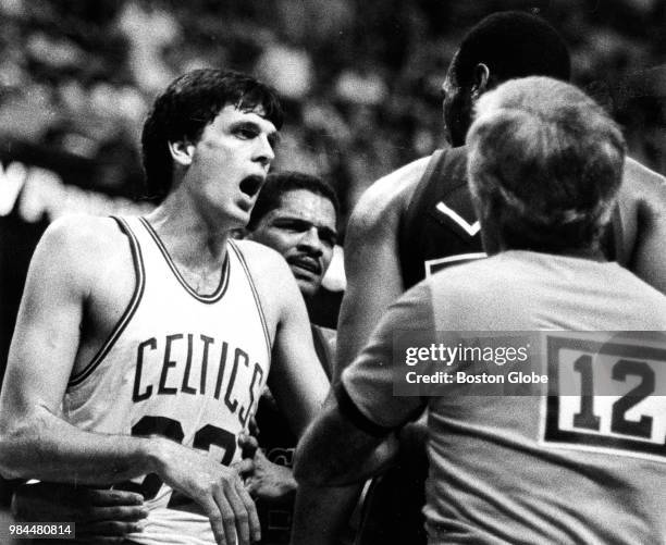 Referee moves to step in between Boston Celtics' Kevin McHale, left, and Milwaukee's Alton Lister during Game Two of the second round of the 1983 NBA...