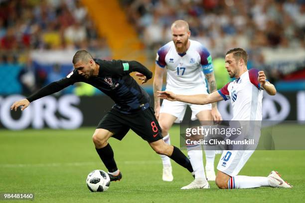 Gylfi Sigurdsson of Iceland tackles Mateo Kovacic of Croatia as Aron Gunnarsson looks on during the 2018 FIFA World Cup Russia group D match between...
