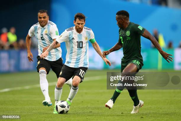 Lionel Messi of Argentina is challenged by Kenneth Omeruo of Nigeria during the 2018 FIFA World Cup Russia group D match between Nigeria and...