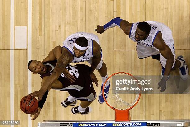 DeMarcus Cousins of the Kentucky Wildcats blocks a shot attempt by Kodi Augustus of the Mississippi State Bulldogs during the final of the SEC Men's...