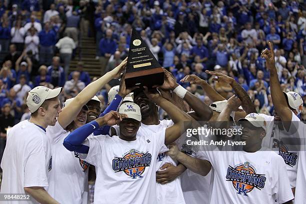 John Wall of the Kentucky Wildcats celebrates with the trophy along with his teammates after they won 75-74 in overtime against the Mississippi State...