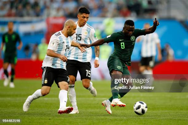 Oghenekaro Etebo of Nigeria is challenged by Javier Mascherano and Enzo Perez of Argentina during the 2018 FIFA World Cup Russia group D match...