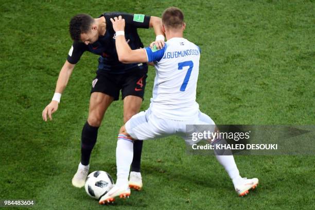 Iceland's midfielder Johann Gudmundsson challenges Croatia's forward Ivan Perisic during the Russia 2018 World Cup Group D football match between...