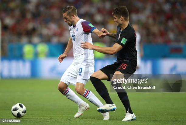 Gylfi Sigurdsson of Iceland fends off Duje Caleta-Car of Croatia during the 2018 FIFA World Cup Russia group D match between Iceland and Croatia at...