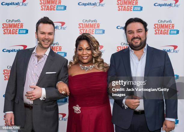 Canadian baritone Joshua Hopkins, American soprano Latonia Moore, and Guatemalan tenor Mario Chang pose backstage for photographs prior to performing...