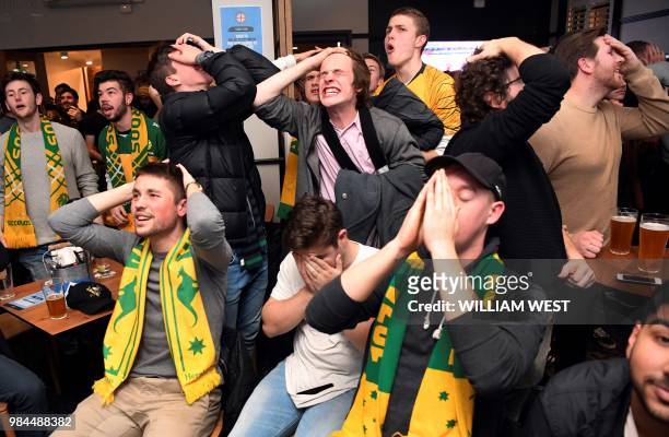 Australian fans react in a pub in Melbourne early June 27 as they watch Australia play Peru in their Russia 2018 World Cup Group C football match on...