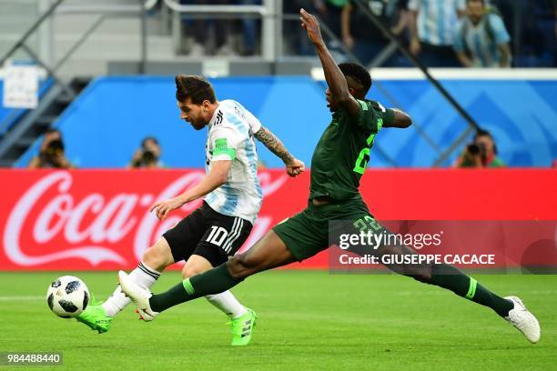 Argentina's forward Lionel Messi shoots score as he is marked by Nigeria's defender Kenneth Omeruo during the Russia 2018 World Cup Group D football...