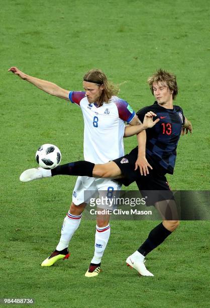 Birkir Bjarnason of Iceland is challenged by Tin Jedvaj of Croatia during the 2018 FIFA World Cup Russia group D match between Iceland and Croatia at...