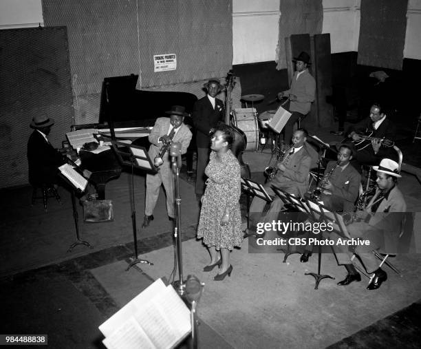 Jazz singer Billie Holiday and band at recording session. New York, NY. Left to right, Sonny White , Roy Eldridge , John Williams , Billie Holiday,...