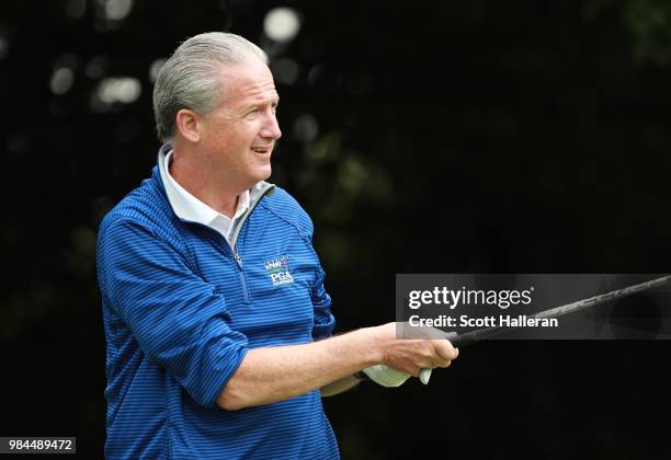 Scott Ozanus of KPMG watches a tee shot during the pro-am prior to the start of the KPMG Women's PGA Championship at Kemper Lakes Golf Club on June...