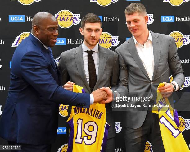 Magic Johnson, the Los Angeles Lakers president of basketball operations, shakes hands with the team's 2018 NBA draft picks Moritz Wagner and...